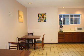 Two Dinning Tables and Microwave in Lobby